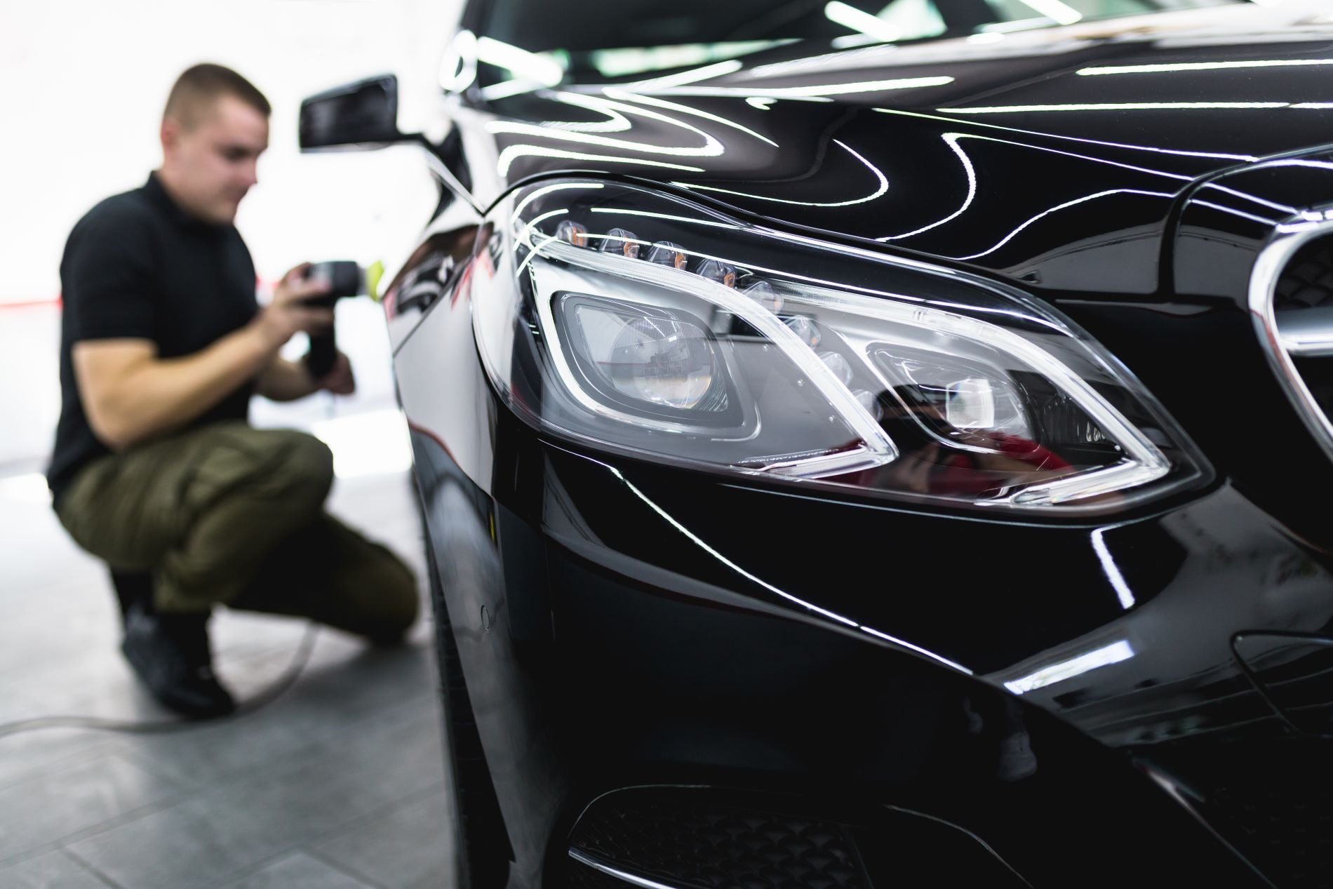 Mechanics at an auto body shops specializing in car scratch repair, primer scratches, and base coat scratches.